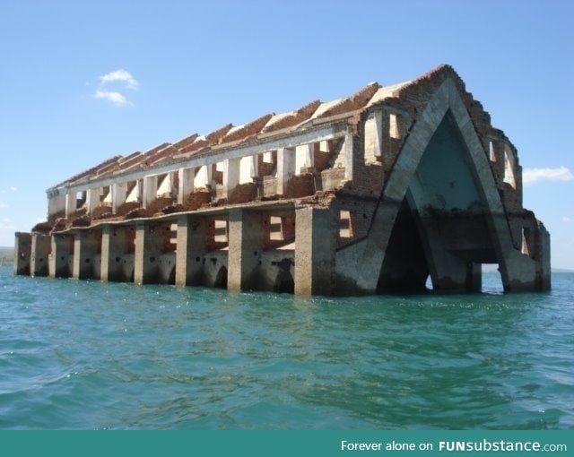 Arches of a church that is abandoned in Brazil being swallowed by the sea