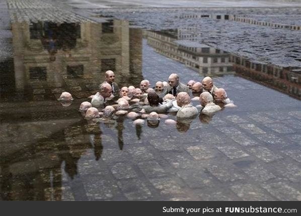 This is a statue in Berlin called "Politicians discussing Global Warming."