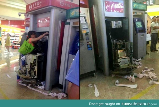 A woman dismantles an ATM after it swallows her card in Dongguan, Guangdong Province,