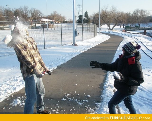 A perfectly-timed snapshot from a sibling snowball fight