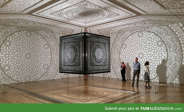 Laser cut wooden cube suspended from the ceiling