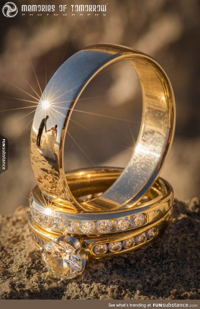 This wedding ring photo has reflections of the newlyweds