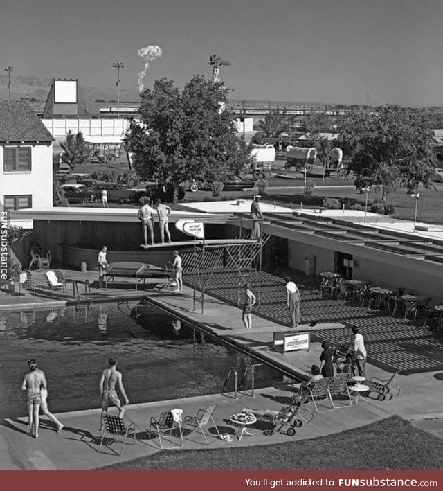 People in Vegas watch a mushroom cloud rise in 1953