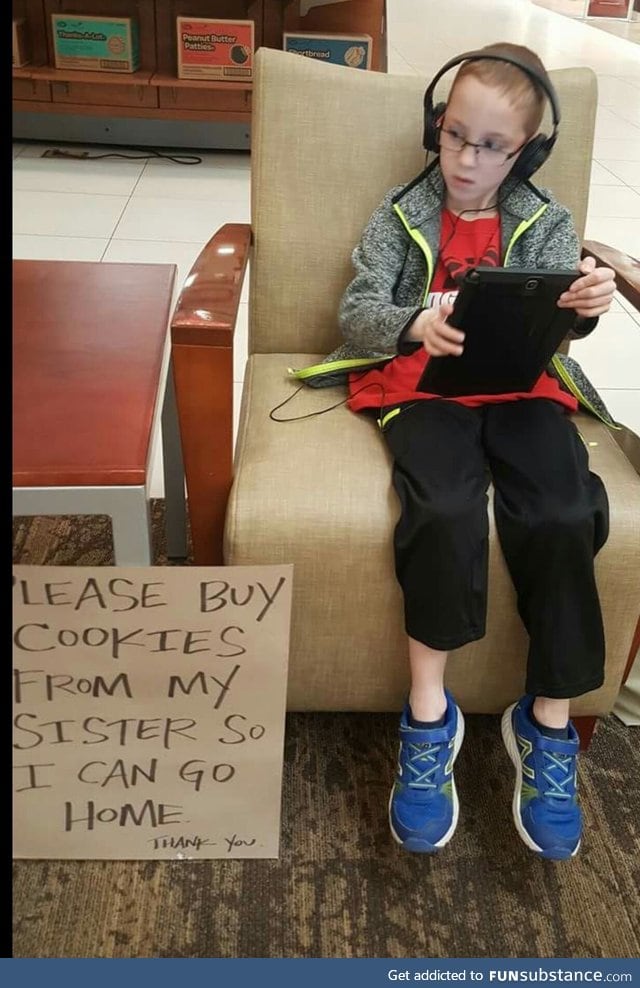 A brother helps his sister sell Girl Scout cookies.