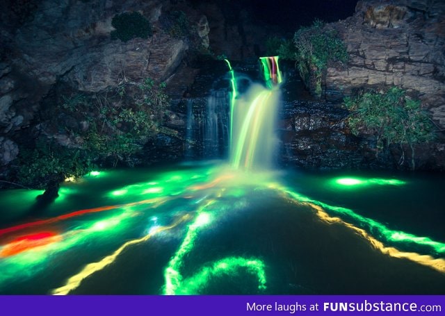 Dropped glow sticks into a waterfall