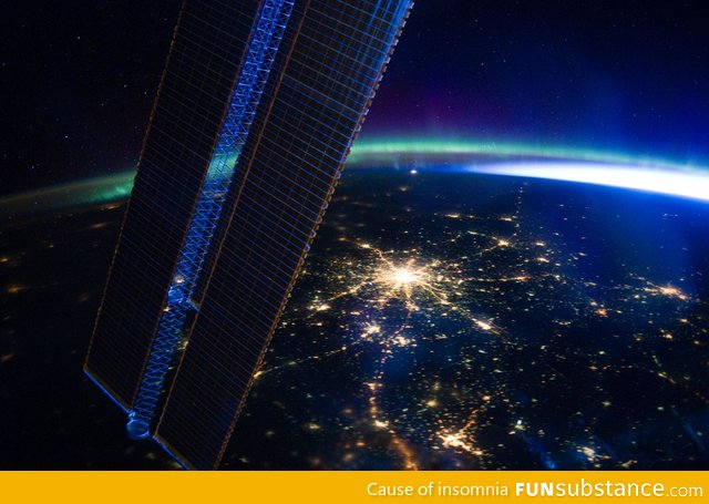 Moscow at night as seen from the ISS, with Aurora Borealis in the background