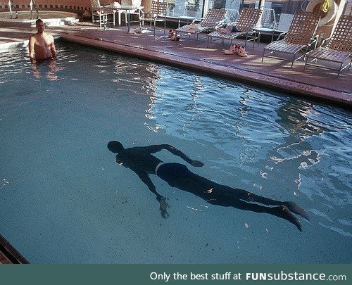 7’7” former NBA player Manute Bol in a pool