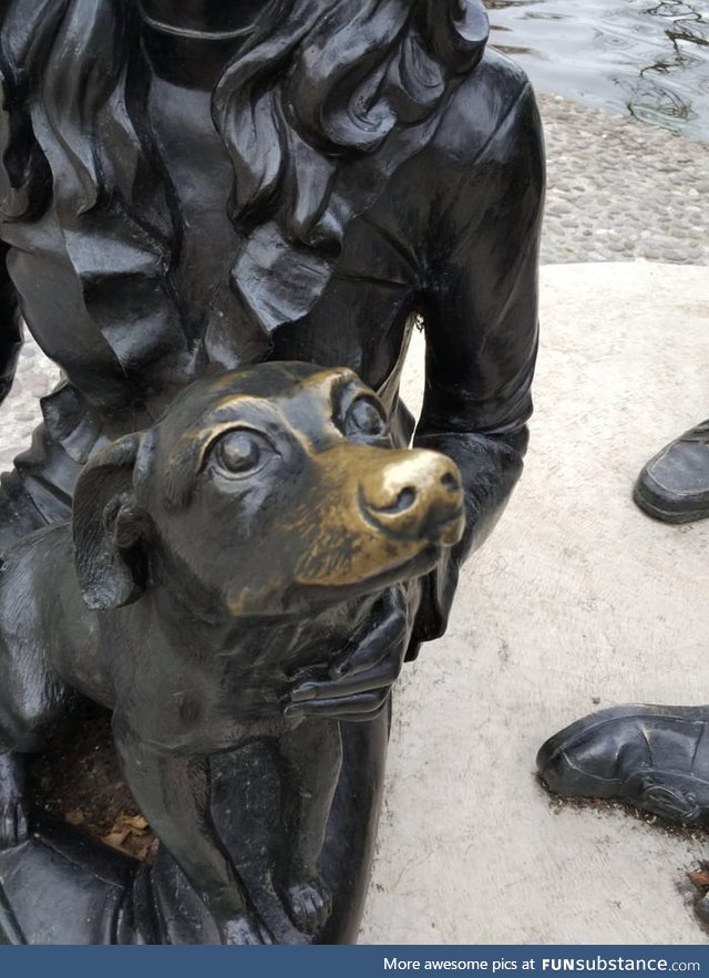 This statue dog's nose is worn away from all the people who pet it