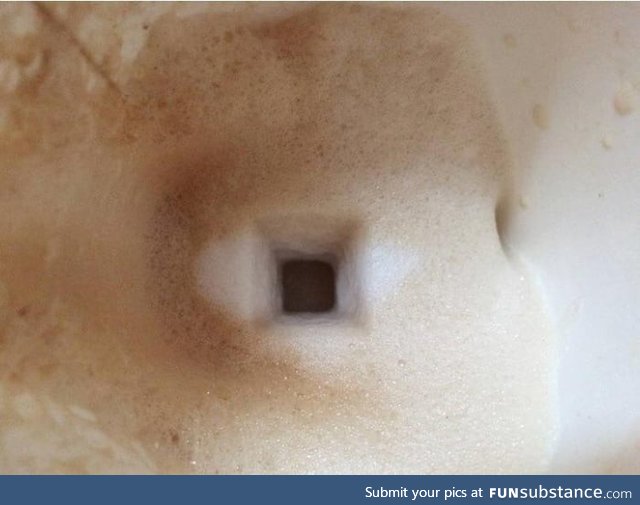 The trail of the sugar cube falling through the milk froth