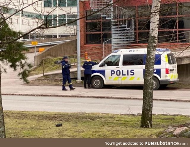 Traffic warden giving a ticket to police in Helsinki, Finland