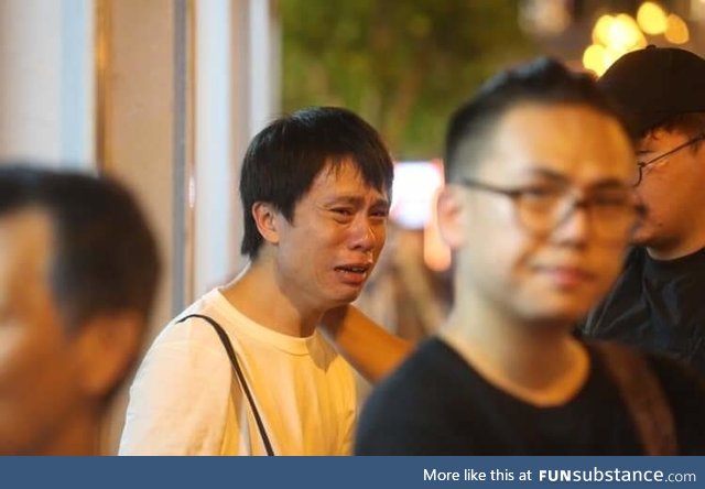 Hong Kong councillor Roy Kwong cries in agony as a protestor commited suicide to protest