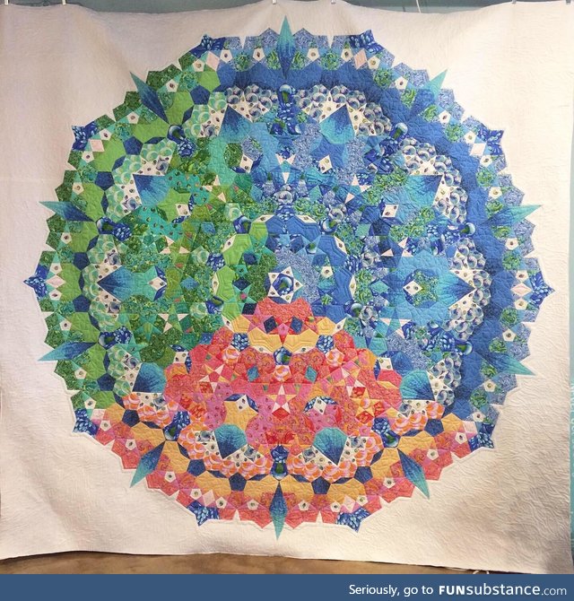 I made this 9 foot tall quilt by hand-sewing 1,288 pieces of fabric together. About