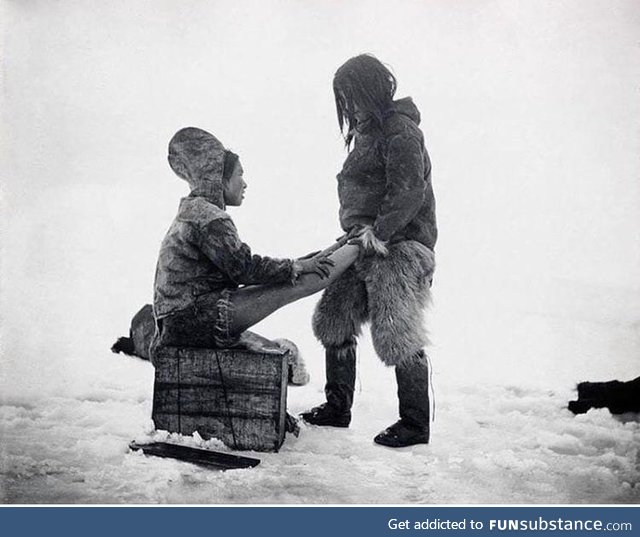 The Inuit man from Greenland warms the wife’s feet, circa 1891