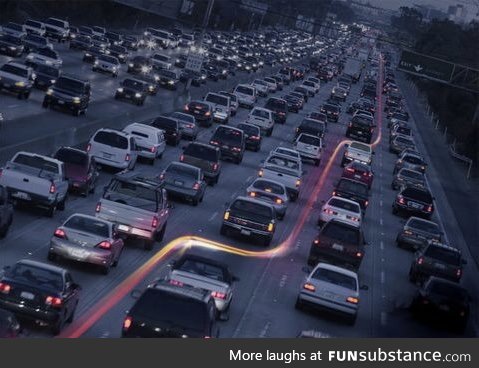 Long exposure of a motorbike through a traffic jam.