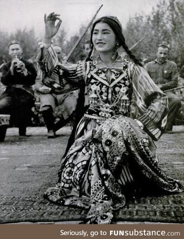 Uighur dancer performing to music, Xinjiang, China, circa 1943
