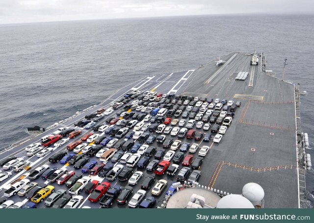 Just a bunch of cars parked on the deck of an aircraft carrier