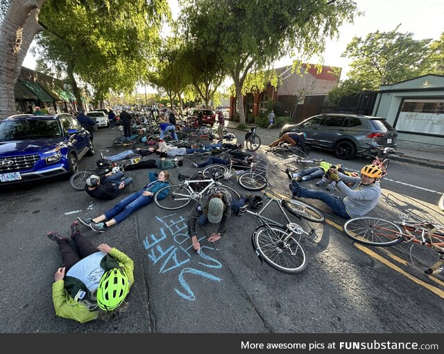 Supporters of the proposal for a bike lane on Hopkins Street are holding a “die-in”
