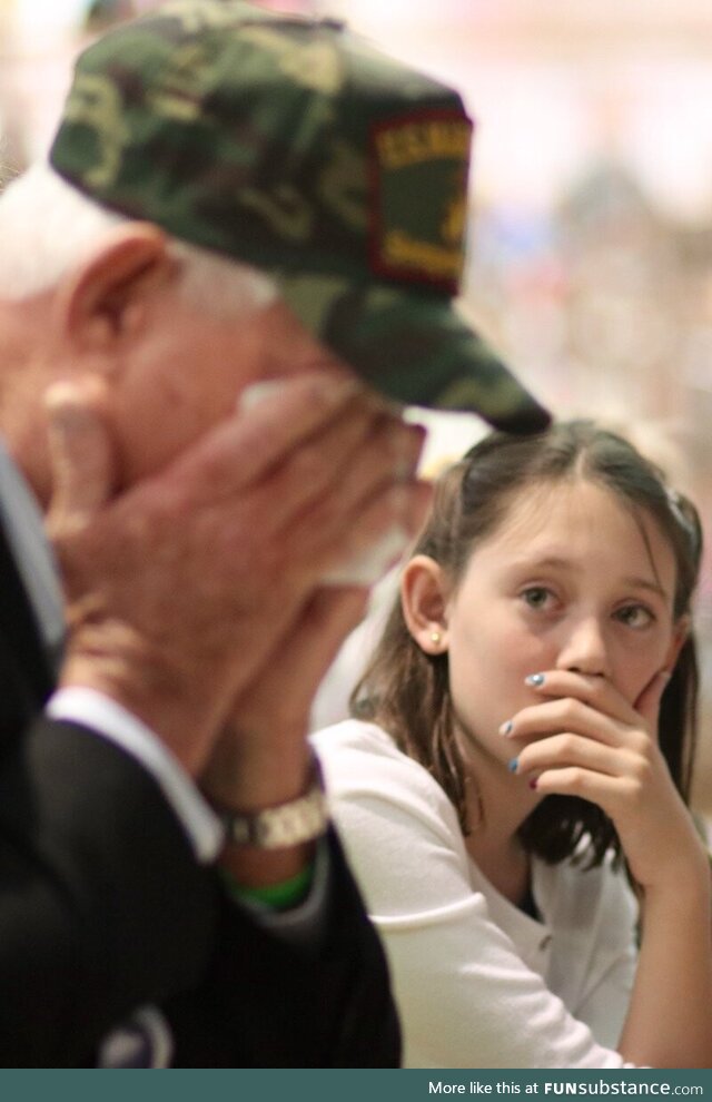Granddaughter watching her grandfather break into tears at her school's Veterans Day