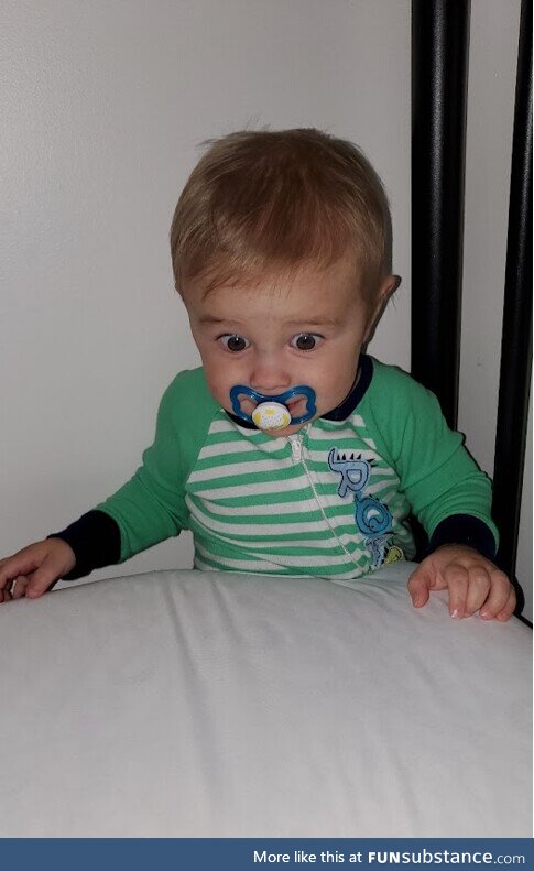 My son was jumping on the bed and landed between the mattress and the wall, his look of