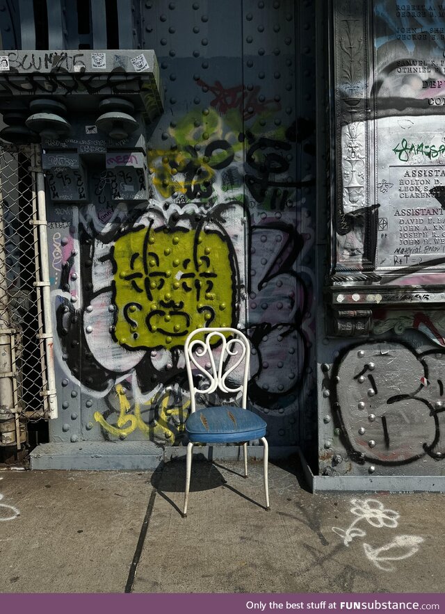 A chair in the middle of the Manhattan bridge