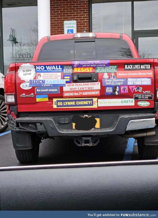 A red truck with stickers on the back