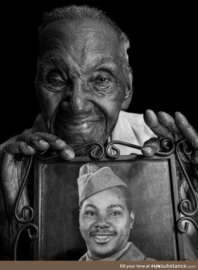 Lawrence Brooks, a 96-year-old World War II veteran holding a photo of himself taken