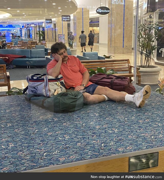 This is not a middle-aged guy tired from traveling - it's a bronze sculpture in an