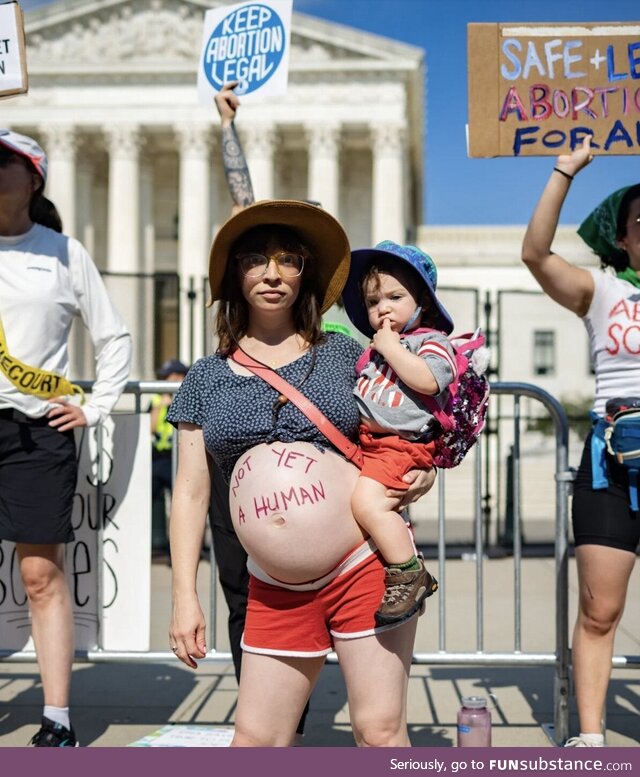 Pregnant woman protesting against supreme court decision about Roe v. Wade
