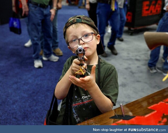 A 6-year-old from Indiana trying out a gun during the NRA's annual convention in 2023
