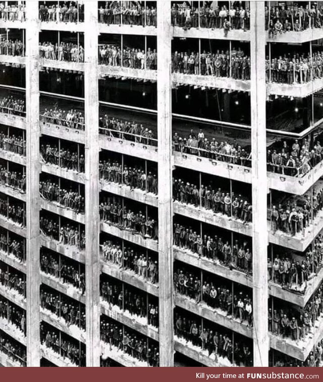 3000 men who constructed the Chase Manhattan Bank in NYC pose for a photo nearing its