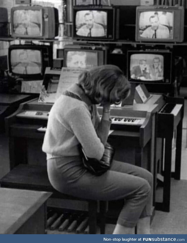 60 year old photo taken at a Sears Department Store as the news of JFKs assassination