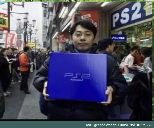 A Japanese man holding his newly acquired PS2 in the launching day in Japan. March 4 2000