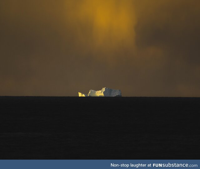 Took a sunset shot of this huge iceberg far away in the distant in the Atlantic Ocean