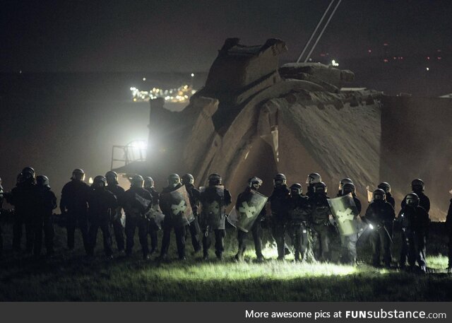 German police protect an opencast mine of a company that destroys a village in order to