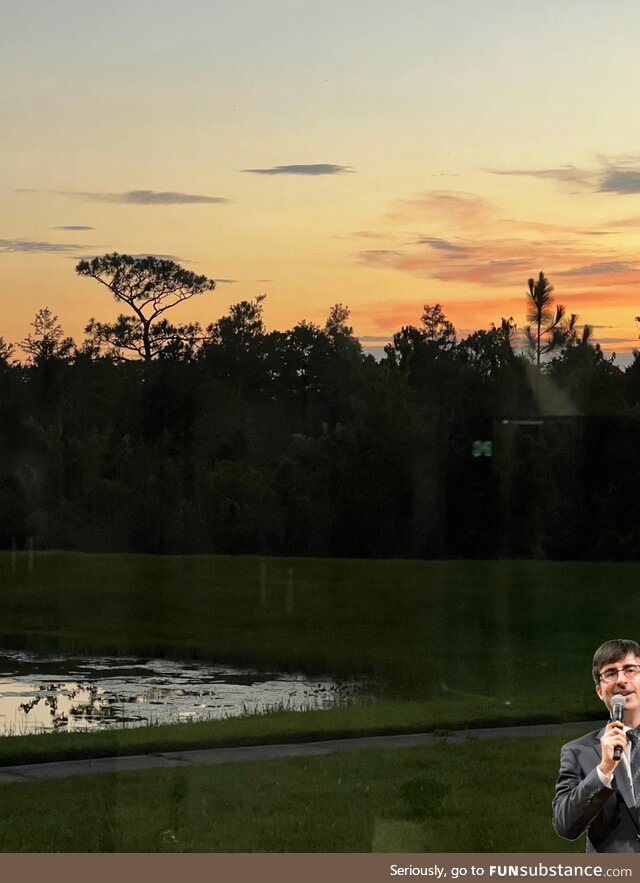 John oliver exploring swampy land under rainbow sky