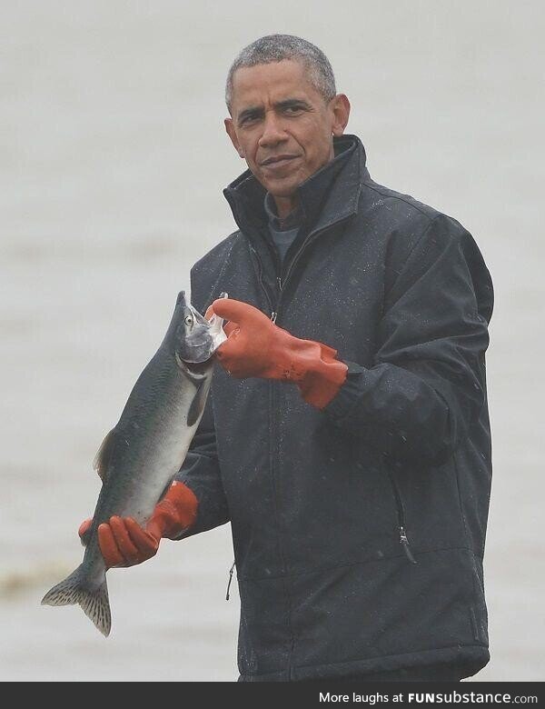 President Barack Obama poses with a fish