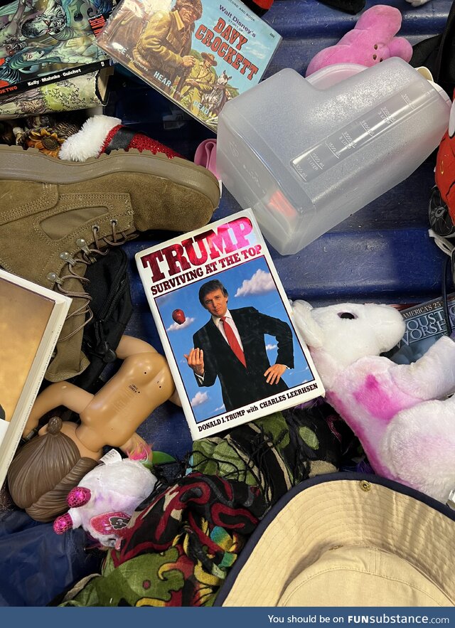 Trump's book "Surviving at the Top" at the bottom of a goodwill outlet bin