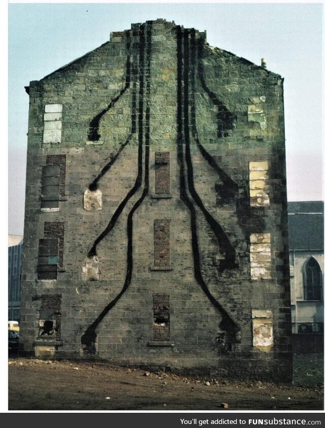 A Glasgow tenement building during demolition, 1972, showing soot trails to chimneys