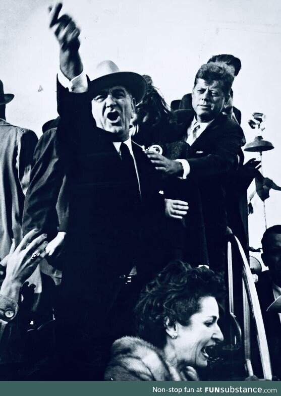 Lyndon b. Johnson yelling to quiet down as john f. Kennedy holds him back. Campaigning