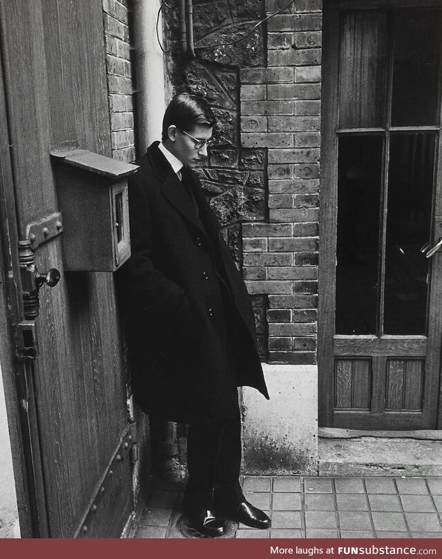 Yves Saint Laurent standing alone at his mentor, Christian Dior's funeral