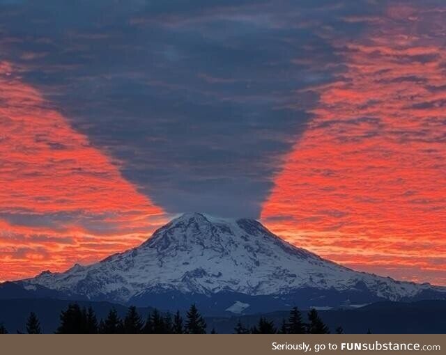 Mount Rainier casting a shadow on the morning sky