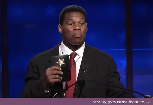 Herschel Walker flashes a fake badge during the Georgia senate debate
