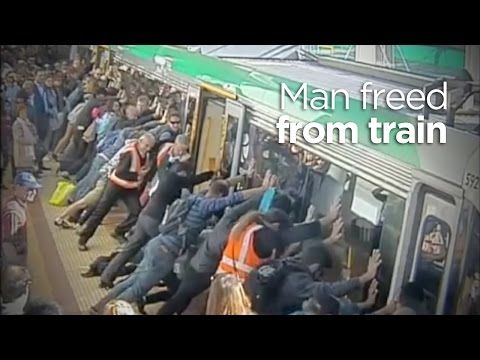 People power frees man trapped in between platform and train