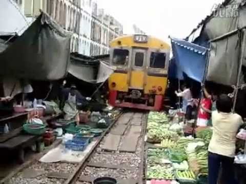 This vegetable market is so close to the train tracks!