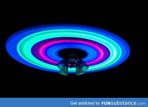 Glow sticks attached to the blades of a ceiling fan