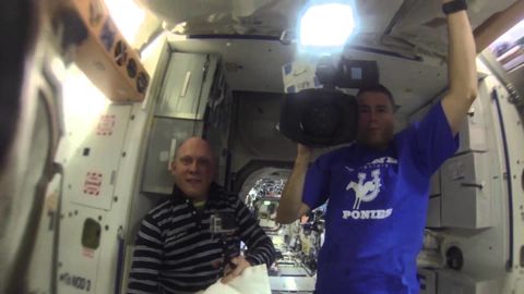 Astronauts play with a water bubble in space. They even put a GoPro in it!