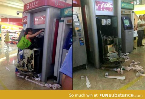 A woman dismantles an ATM after it swallows her card in Dongguan, Guangdong Province,