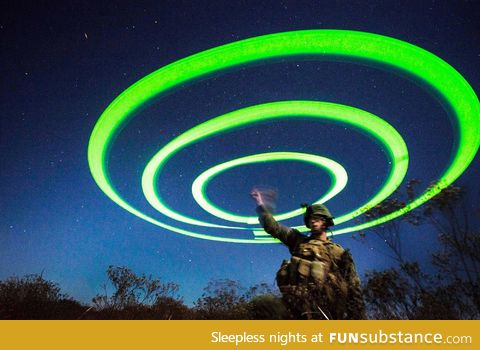 US Marine uses string of chem lights to signal landing zone for V-22 Osprey