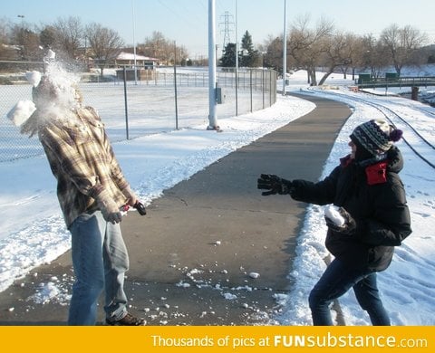 A perfectly-timed snapshot from a sibling snowball fight