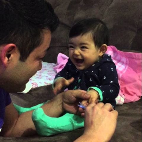 Adorable baby fakes crying when daddy tries to cut her fingernails